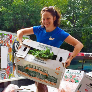 Sarah holding box of veggies